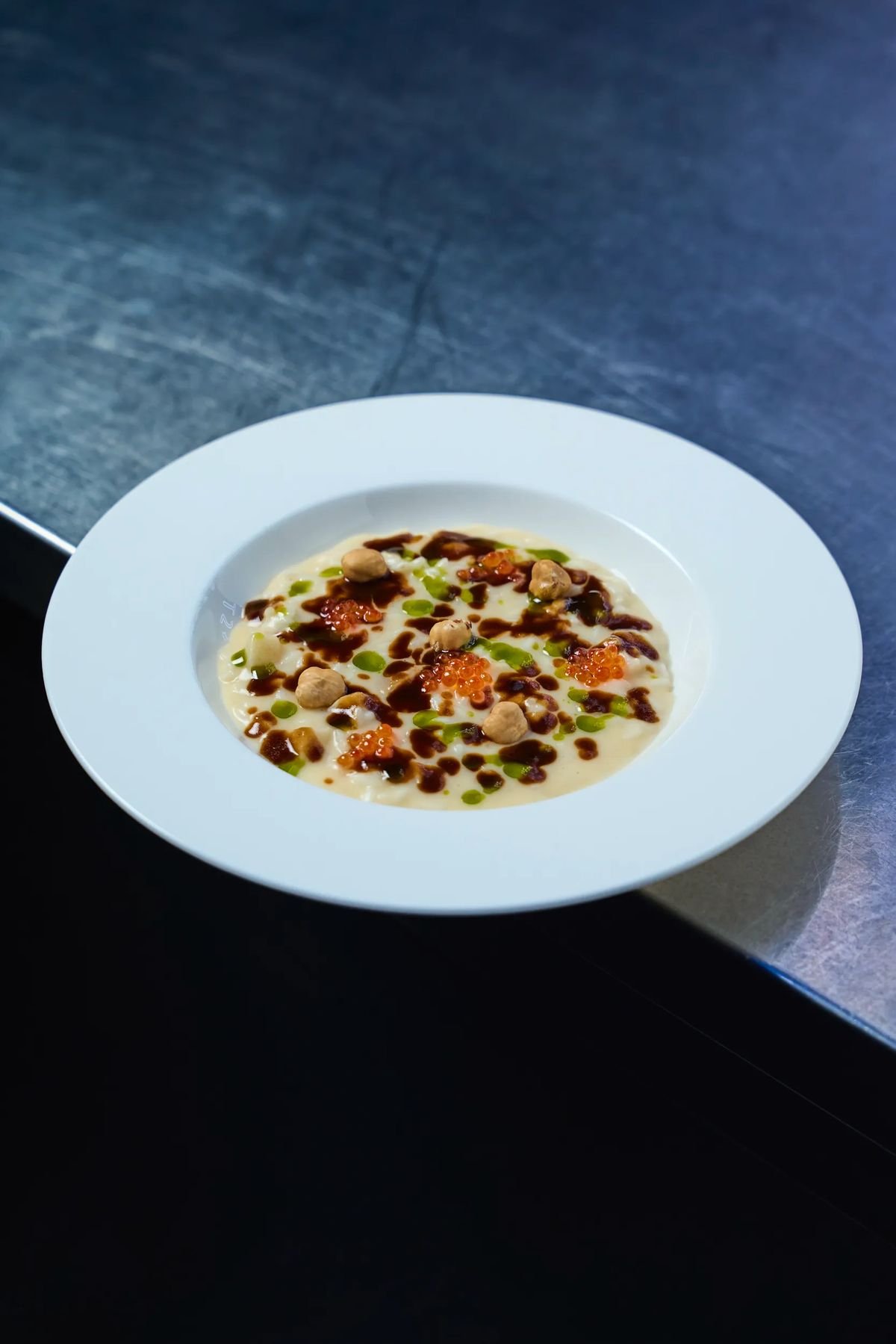 Risotto cremoso con uova di salmone, porcini e riduzione di balsamico